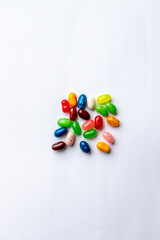 Close up top view texture background of colorful jellybeans randomly grouped on a white background