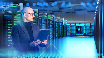 Data center engineer supervises AI-powered server infrastructure using a tablet, managing digital systems, network performance and high-capacity computing operations.