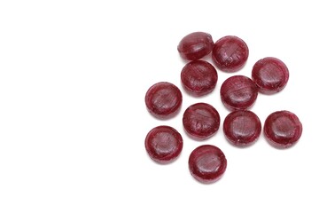 Dark red sugar hard candy drops isolated