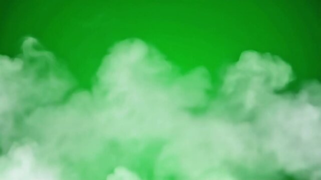Green screen with white smoke clouds against a vibrant green background for chroma key compositing.
