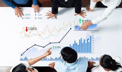 A group of business professionals engage in a collaborative analysis of financial graphs and charts, highlighting strategic discussions to drive market growth. Scalp