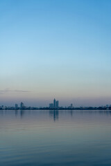 Naklejka premium Skyline of Hanoi Reflected on Hồ Tây (West Lake) at Dusk, Vietnam