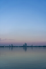 Obraz premium Skyline of Hanoi Reflected on Hồ Tây (West Lake) at Dusk, Vietnam