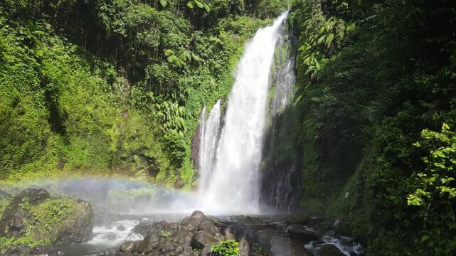 Aerial Footage of Gomblang Waterfall with Rainbow in Dense Forest, Java Island, Indonesia