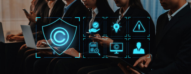 A group of business professionals engaged in a conference setting, using modern technology while digital copyright symbols represent security and innovation concepts. Trope