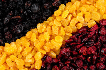 Dried cranberries and raisins background texture with sun dried golden raisins