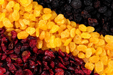 Dried cranberries and raisins background texture with sun dried golden raisins