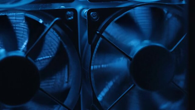 Rotating fans with blue light, cooling computer hardware, closeup