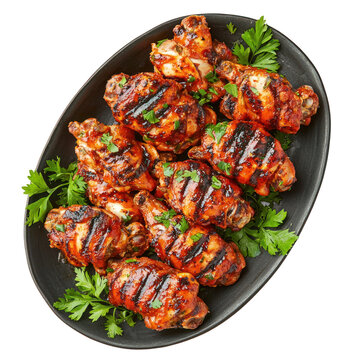 A plate of grilled chicken wings with a spicy sauce and garnished with fresh parsley.