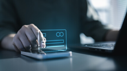 A person using a smartphone with a holographic digital credit card interface, representing secure online payment, fintech technology, and protected financial transactions in a digital environment.