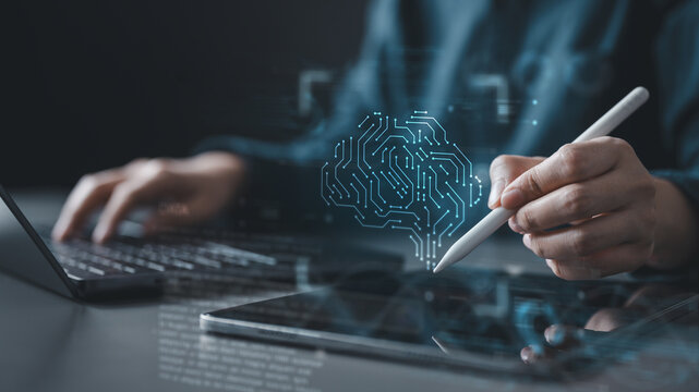 A person using a stylus on a digital tablet with a glowing AI brain graphic, representing machine learning, neural networks, data algorithms, and modern artificial intelligence technology.