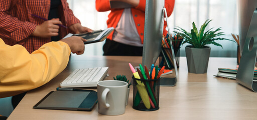 Colleagues in a modern office engage in a productive discussion while collaborating on digital devices. Bright surroundings and creative atmosphere enhance team interaction. SACTR