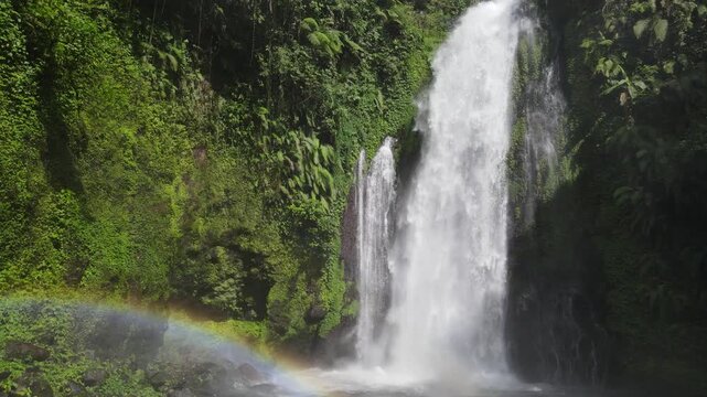 Aerial Footage of Gomblang Waterfall with Rainbow in Dense Forest, Java Island, Indonesia
