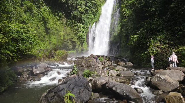 Aerial Footage of Gomblang Waterfall with Rainbow in Dense Forest, Java Island, Indonesia