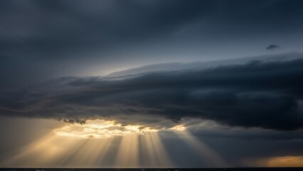 Obraz premium Dramatic Sky with Sun Rays Piercing Through Dark Clouds.