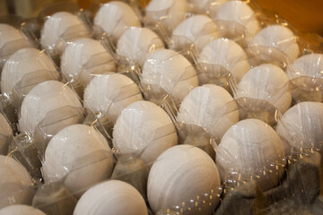 
A carton of eggs with a plastic lid