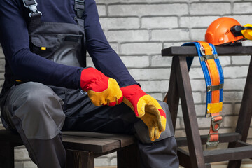  worker wearing putting protective safety glove. Safety equipment. Safety at work concept.