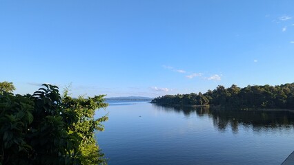 Calm Lake with Blue Sky and Green Trees
