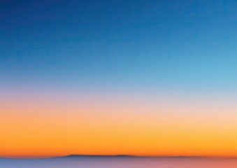 Obraz premium Gradient sky fading from blue to orange/peach, distant horizon