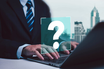 Businessman showing question mark on laptop. Concept of asking, answering, business FAQ, thinking and wondering, brainstorming and problem solving.