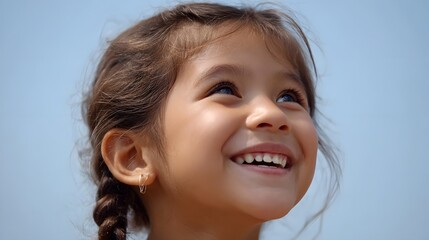 A happy young girl smiling at the blue sky embodying joy and optimism