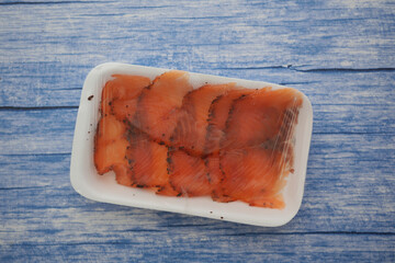 Sliced salmon packed in plastic for sale at a market