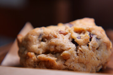 Chocolate chip cookie on wooden table in kitchen setting