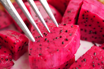 Sliced dragon fruit on a plate with fork ready to eat