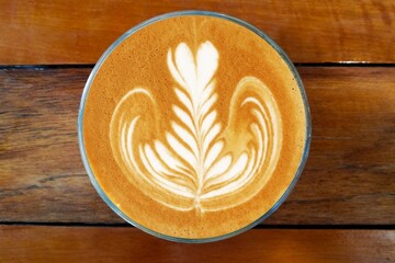 a cup of latte art coffee on wooden background                                                                      