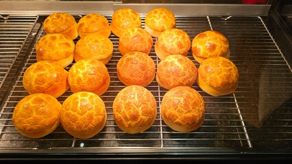 The process of making baking keep warm delicious Hong Kong-style pineapple bun with slice of cold butter by a bakery shop staff — traditional sweet pastry street snack cute mushroom shape bread