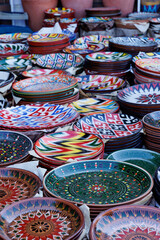 Fototapeta premium October 30, 2025 Tashkent, Uzbekistan. a vibrant collection of hand-painted ceramic plates, each boasting intricate folk patterns