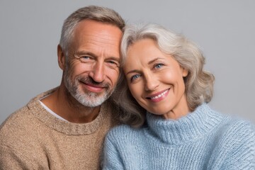 Happy senior couple smiling and embracing each other in a cozy moment showing their love and joy indoors during a calm afternoon