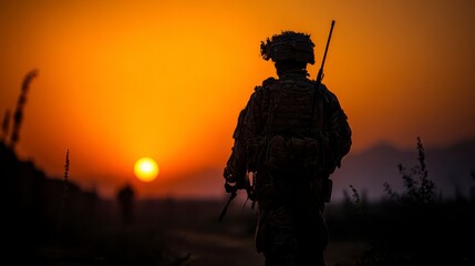 Obraz premium Warrior's Sunset Silhouette: A lone warrior, silhouetted against a fiery sunset, embodies resilience and dedication, against the backdrop of a distant mountain range.