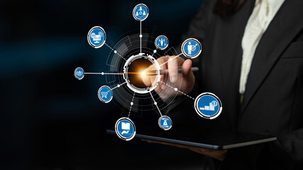 A businesswoman engages with innovative digital icons on a tablet, illustrating connections in technology and communication, enhancing modern business strategies. Crux