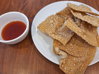 Golden-fried Indonesian dumplings stuffed with minced chicken, served with sweet tomato sauce.