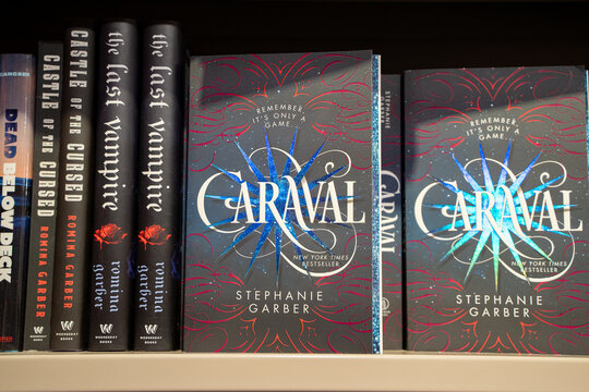 View of fantasy novels displayed on bookstore shelf with Caraval by Stephanie Garber. Toronto, Canada - December 3, 2025.