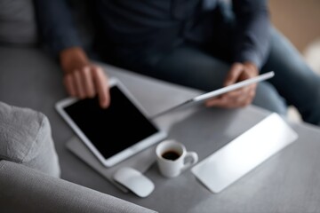 Remote worker multitasking with laptop, tablet, and smartphone illustrating connected digital living