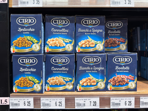 Variety of Cirio canned beans and lentils displayed on a grocery store shelf