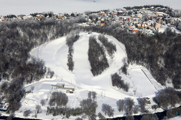 Aerial view of snowy ski resort with winding slopes
