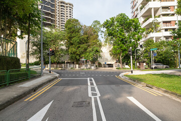 Orchard Road intersection with traffic lights and lush greenery in Singapore