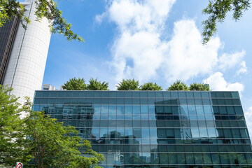Modern glass building with greenery on Orchard Road in Singapore