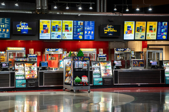 View of movie theater concession stand with illuminated menus. Toronto, Canada - December 3, 2025.