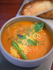 tomato soup on wood table in restaurant