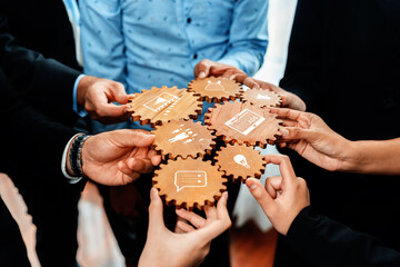 A vibrant scene showing diverse hands holding gears featuring icons that symbolize teamwork, communication, and collaboration, conveying a strong message of unity and shared goals. Amity