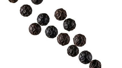 Diagonal line of aromatic black peppercorns on pure white backdrop featuring rich textures and details offering versatile culinary applications