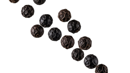 Diagonal line of aromatic black peppercorns on pure white backdrop featuring rich textures and details offering versatile culinary applications
