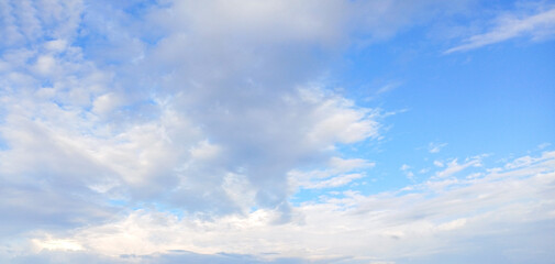 Bright blue sky with soft clouds and wide horizon for peaceful outdoor scenery Demonstration Color of the Year 2026