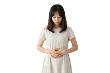 Asian woman in white dress holding her belly with eyes closed