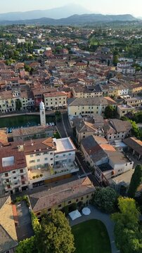 Lazise historic charming medieval walled town in Italy, aerial drone over old port
