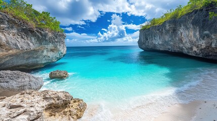 Secluded tropical cove features brilliant turquoise water framed by dramatic limestone cliffs and lush green vegetation